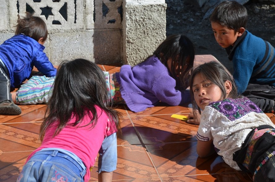 Children playing outside cooperative meeting