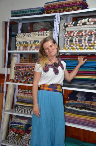 Irena poses in front of Y'abal's fabric stock during her trip to Quetzaltenango in April 2024. 
